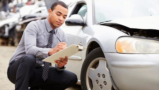 Mechanic inspecting car panel